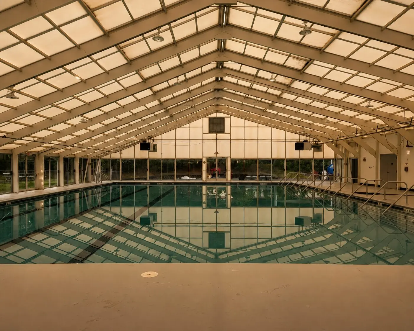 Indoor pool at Sanctuary Fitness, beneath a vaulted roof that brings in natural light.