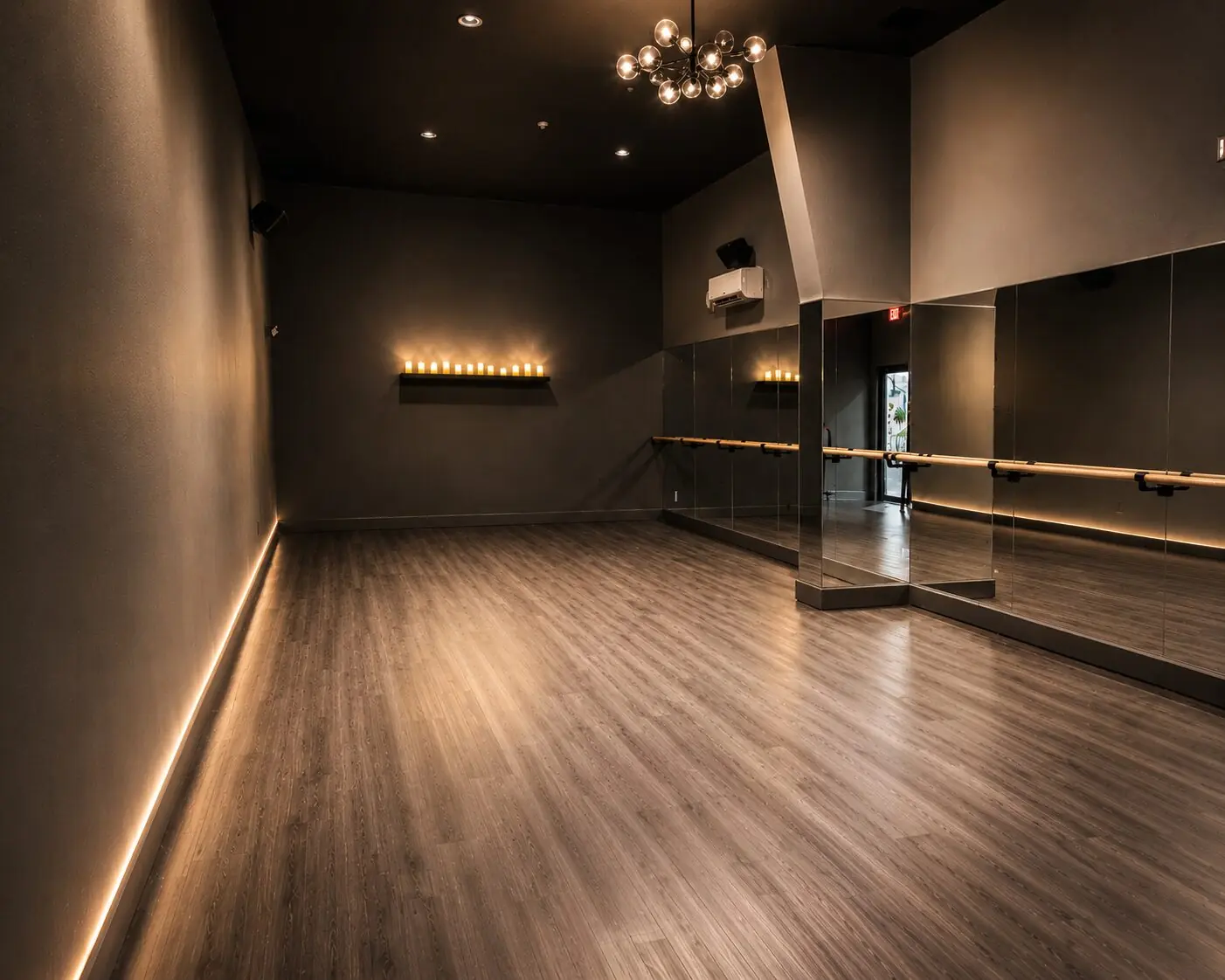 Group fitness studio with hardwood floors and a mirrored wall at Sanctuary Fitness Marlboro